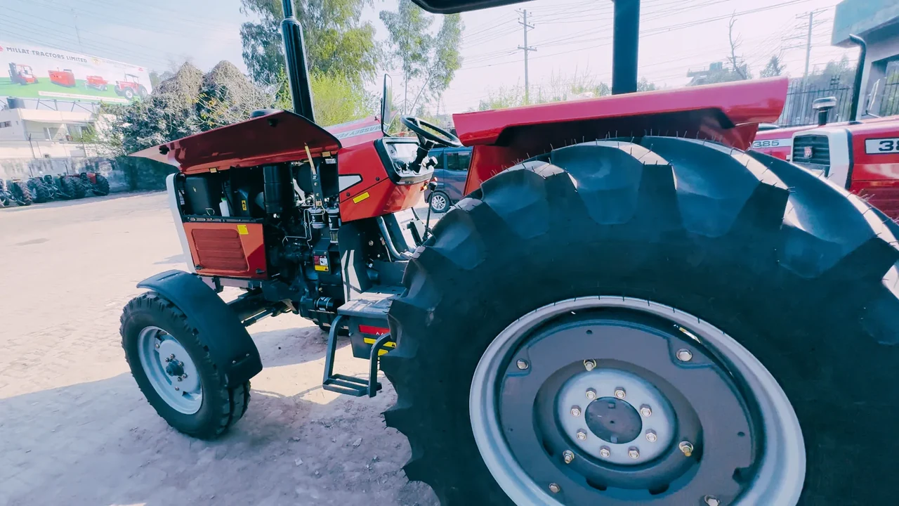 Rear-side archive view of an MF 385 Deluxe tractor